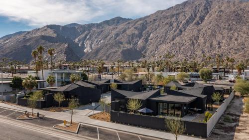 an aerial view of a building with mountains in the background at Blackhaus Full Buyout by AvantStay 16-Room Hotel in Palm Springs