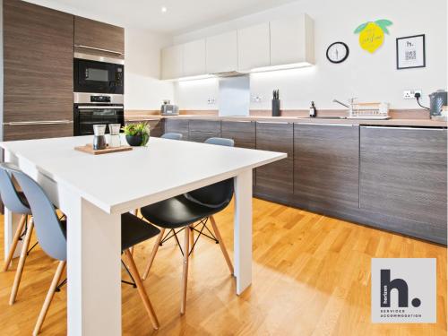 a kitchen with a white table and chairs at FREE Parking - City Centre - Contractors - 20x Units Available in Hull