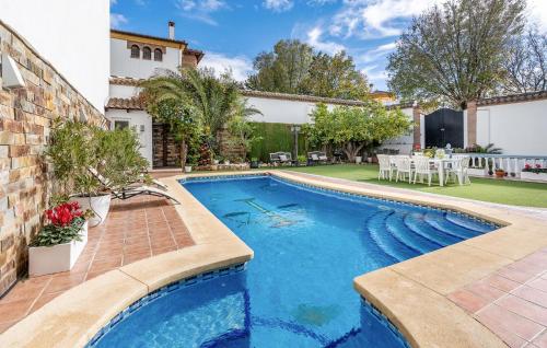 a swimming pool in the backyard of a house at Beautiful Home In Illora in Illora