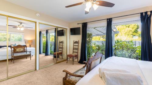 a bedroom with a bed and a balcony at East Valley Manor by AvantStay Minutes to the Beach in Montecito