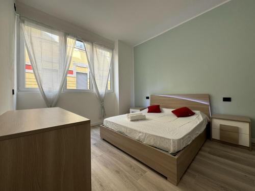 a bedroom with a bed and a large window at Casa Naviglio Charm in Corsico