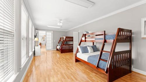 a bedroom with two bunk beds and a hallway at Whitetail Cove by AvantStay Lakefront w Pool Private Dock Sleeps 20 in Terrell
