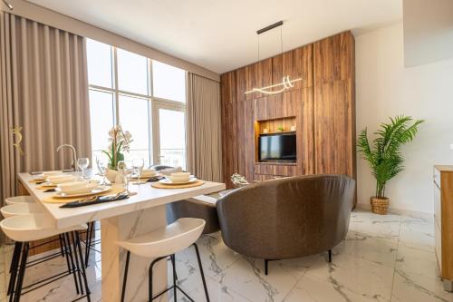 a dining room with a table and chairs at Elegant 4BR Escape - Masdar Chic Retreat in Abu Dhabi