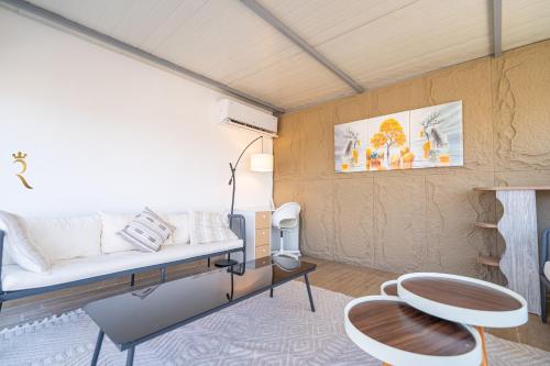 a rendering of a room with a couch and chairs at Elegant 4BR Escape - Masdar Chic Retreat in Abu Dhabi