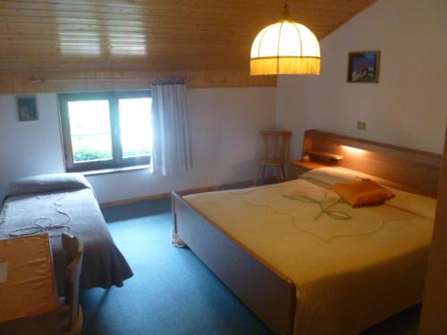 a bedroom with a large bed and a window at Albergo Negritella in Borgo