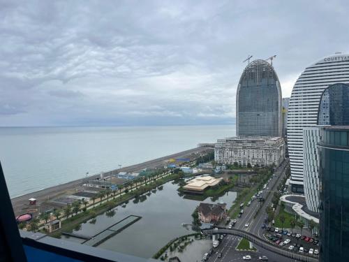 a view of a city with tall buildings and the ocean at Orbi city bloke A in Angisa
