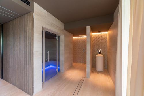 a bathroom with a walk in shower with a blue tub at Hotel Relax Family & Spa in San Benedetto del Tronto