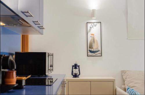 een keuken met een magnetron en een tafel met een televisie bij Sa Perdiu 30 Apartment in Son Carrio