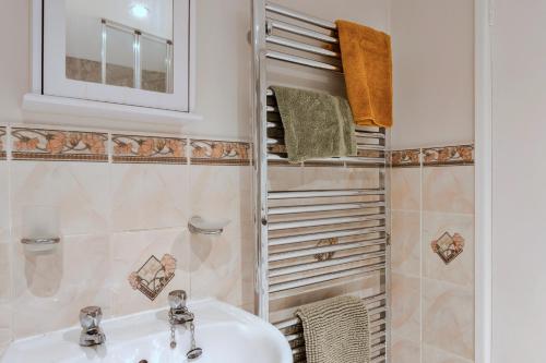 a bathroom with a sink and a shower at Finest Retreats - Town Farm Cottage in Exbourne