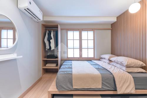 a bedroom with a large bed and a window at Eazystay Gateway Pasteur Apartment in Bandung