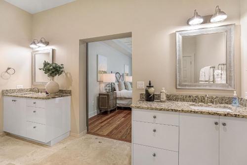 a bathroom with two sinks and a mirror at California Building in New Orleans