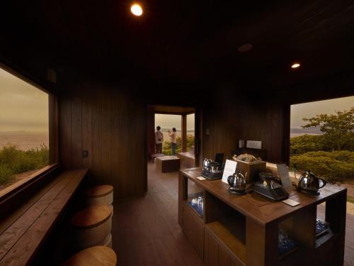 a room with a table and some windows at i + Land Nagasaki in Nagasaki