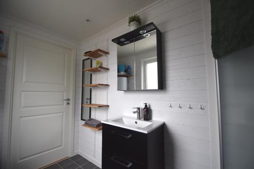 a bathroom with a sink and a mirror at Cottage with sea view at Tjorn Island in Stora Dyrön