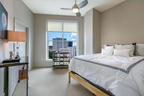 a bedroom with a bed and a large window at California Building in New Orleans
