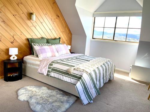 a bedroom with a bed and a window and a rug at Home in Moonah with beautiful view in Moonah