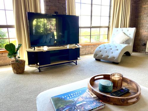 a living room with a tv and a coffee table at Home in Moonah with beautiful view in Moonah