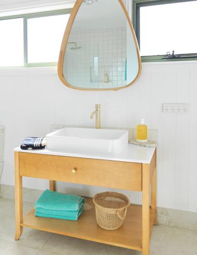 a bathroom with a sink and a mirror at Beilby Inlet Views in Inverloch