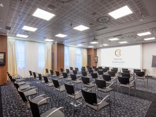 a conference room with chairs and a projection screen at Century Old Town Prague - MGallery Collection in Prague
