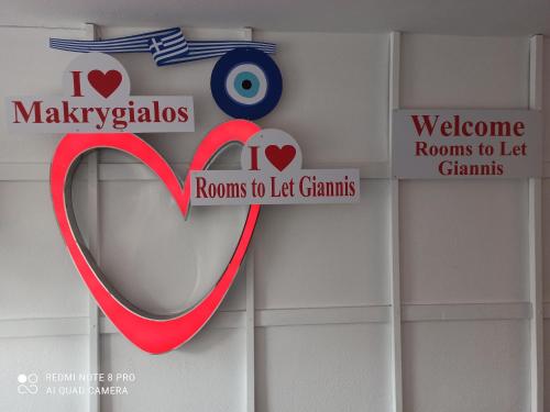 a sign with a heart and a red ribbon at Rooms To Let Giannis in Makrýgialos