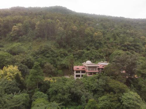 a house in the middle of a forest at Simala Retreat Baiguney in Naya Bāzār