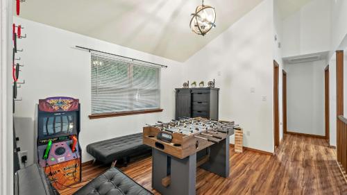 a room with a video game console and a game table at Stylish Mountain Retreat w Hot Tub Firepit Penn Estate Getaway by AvantStay in East Stroudsburg