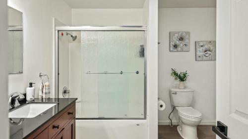 a bathroom with a shower with a toilet and a sink at Stylish Mountain Retreat w Hot Tub Firepit Penn Estate Getaway by AvantStay in East Stroudsburg
