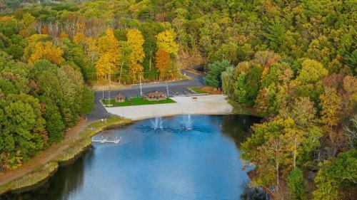 an aerial view of a river in the middle of a forest at Stylish Mountain Retreat w Hot Tub Firepit Penn Estate Getaway by AvantStay in East Stroudsburg