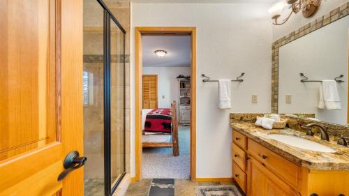 a bathroom with a sink and a mirror at Cozy Escape w Hot Tub Deck & Access to Tahoe Donner & Skiing Alpenglow Chalet by AvantStay in Truckee