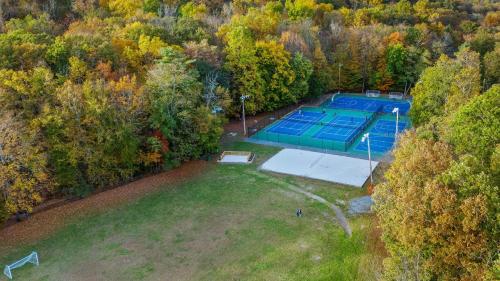an overhead view of a tennis court in a field at Stylish Mountain Retreat w Hot Tub Firepit Penn Estate Getaway by AvantStay in East Stroudsburg