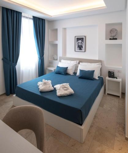 a bedroom with a bed with two towels on it at Hotel Palazzo Antonietta in San Marco di Castellabate