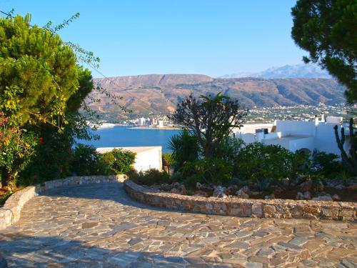 a stone walkway with a view of the water at Panoramic Seaview Holiday House in Souda