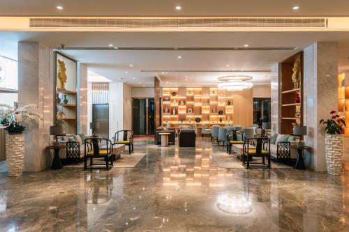 a lobby of a hotel with chairs and tables at Laike Hotel in Bangkok