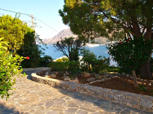 a garden with a view of the water at Panoramic Seaview Holiday House in Souda