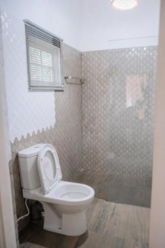 a bathroom with a toilet and a shower at Villa near Negombo & Airport in Andimulla