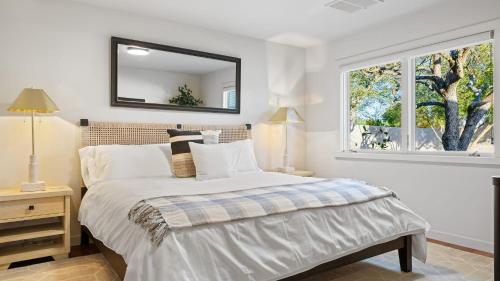 a bedroom with a bed with a mirror on the wall at Wine Country Estate w Pool Hot Tub The Residence at Truss Wines by AvantStay in Paso Robles