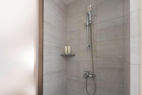 a bathroom with a shower with a shower head at Laike Hotel in Bangkok