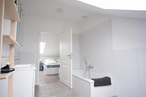 a white bathroom with a tub and a sink at Michelhuus 3 St Michaelisdonn in Westdorf