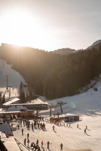 a group of people skiing on a snow covered slope at ADEA Lifestyle Suites Fieberbrunn in Fieberbrunn