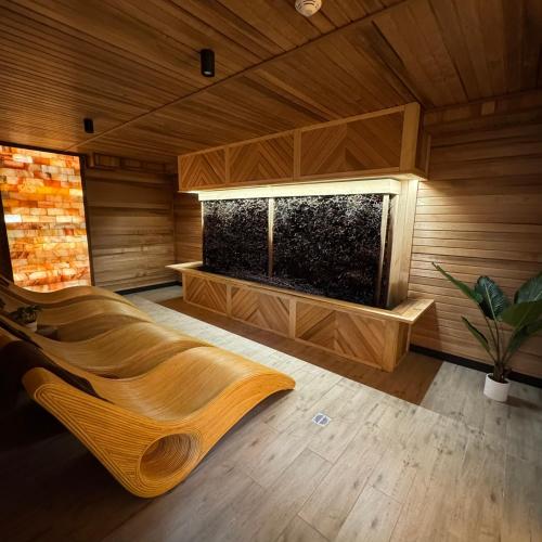 a sauna with a large fish tank in a room at Hotel Vestina in Wisła