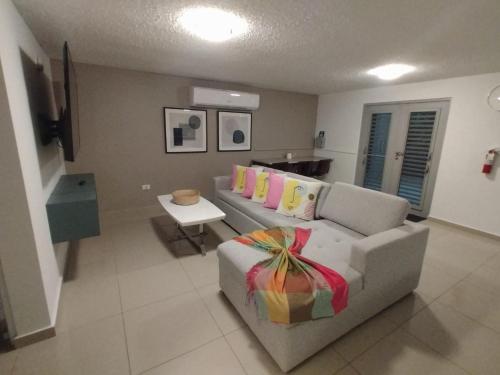 a living room with a couch with a gift on it at Aquaville Dorado Moderna Villa 4 in Dorado