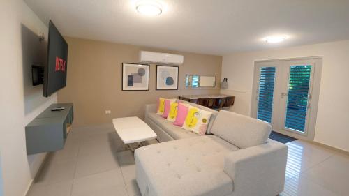 a living room with a couch and a table at Aquaville Dorado Moderna Villa 4 in Dorado