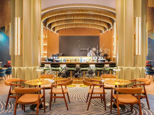 a restaurant with tables and chairs and a bar at Novotel World Trade Centre Dubai in Dubai
