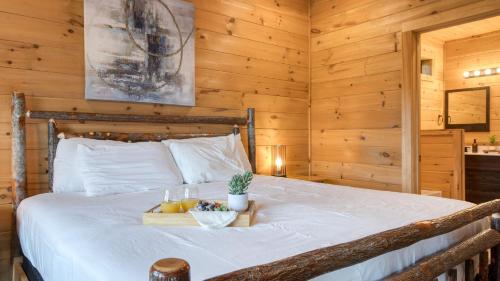 a bedroom with a bed with a tray of fruit on it at Lions Landing by AvantStay Sleeps 18 Hot Tub Game Room Views Near Pigeon Forge in Sevierville