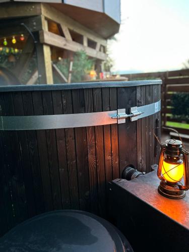a lantern sitting on a table next to a wooden fence at Gite Clé des Champs in Montenois