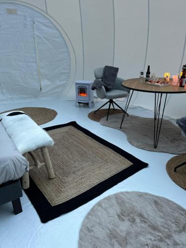 a room with several rugs and a table and a chair at Gite Clé des Champs in Montenois