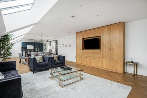 a living room with two couches and a tv at Trafalgar Square Residences in London