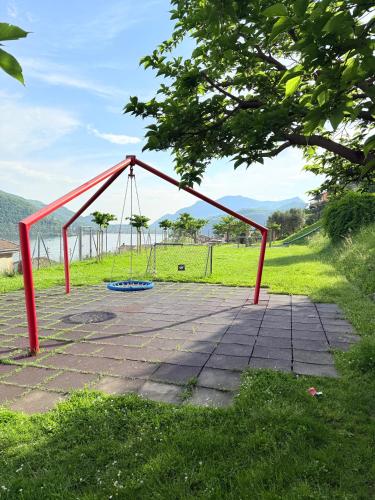 an empty swing set in a park at Gritti Palace Morcote - Camelia - Spacious historic house by the lake in Morcote