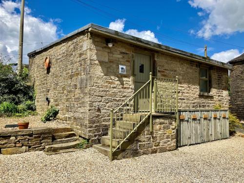 a stone house with a staircase in front of it at The Shearer's Hut in the Peak Park in Holme