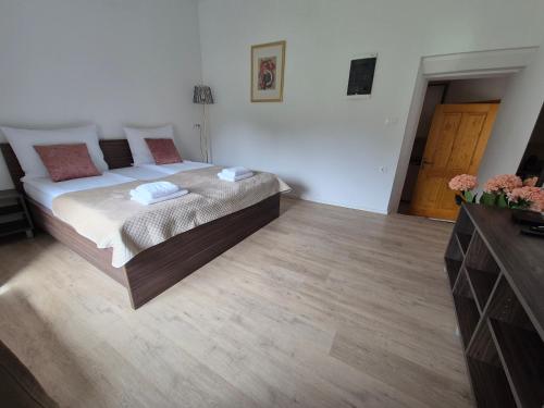 a bedroom with a bed and a wooden floor at Slovenian House Vida in Bled