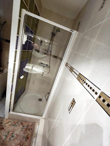 a shower in a bathroom with a glass door at Chambre privée in Le Mée-sur-Seine